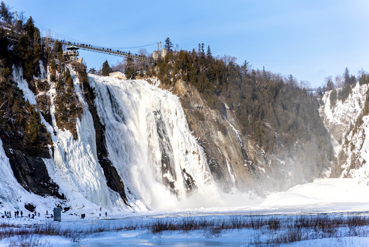 Spectacular winter scene at Montmorency Falls, Quebec, showcasing icy cascades and panoramic views.