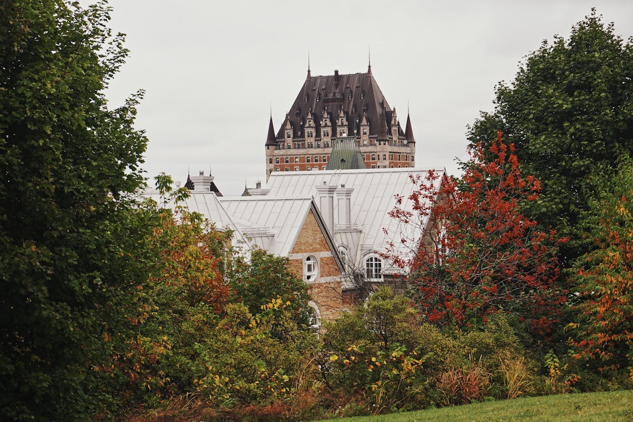 Captivating view of Chateau Frontenac framed by autumn trees in Quebec City.