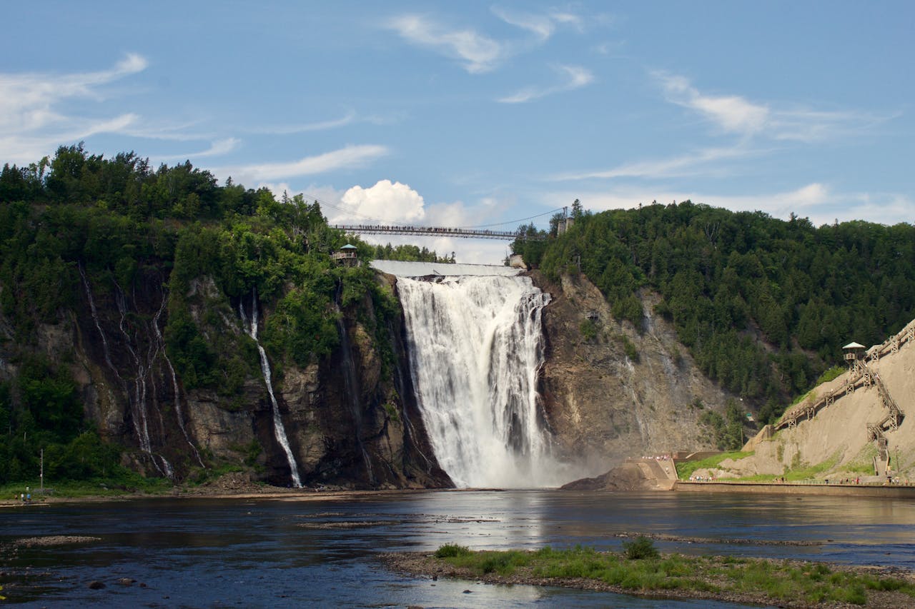 View of Montmorency Falls and bridge during a sunny day.